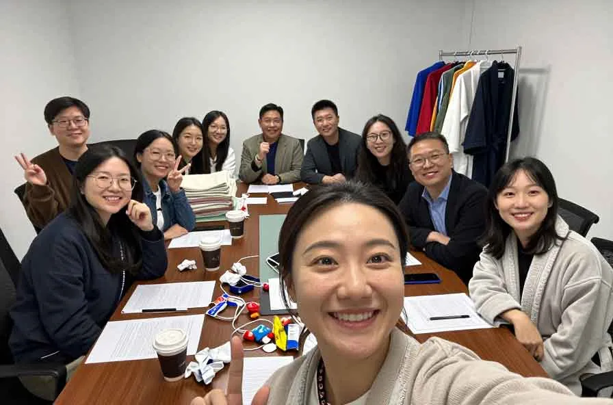 Softextiles team reviewing custom bathrobe samples for private-label, hotel, and spa robe development support.