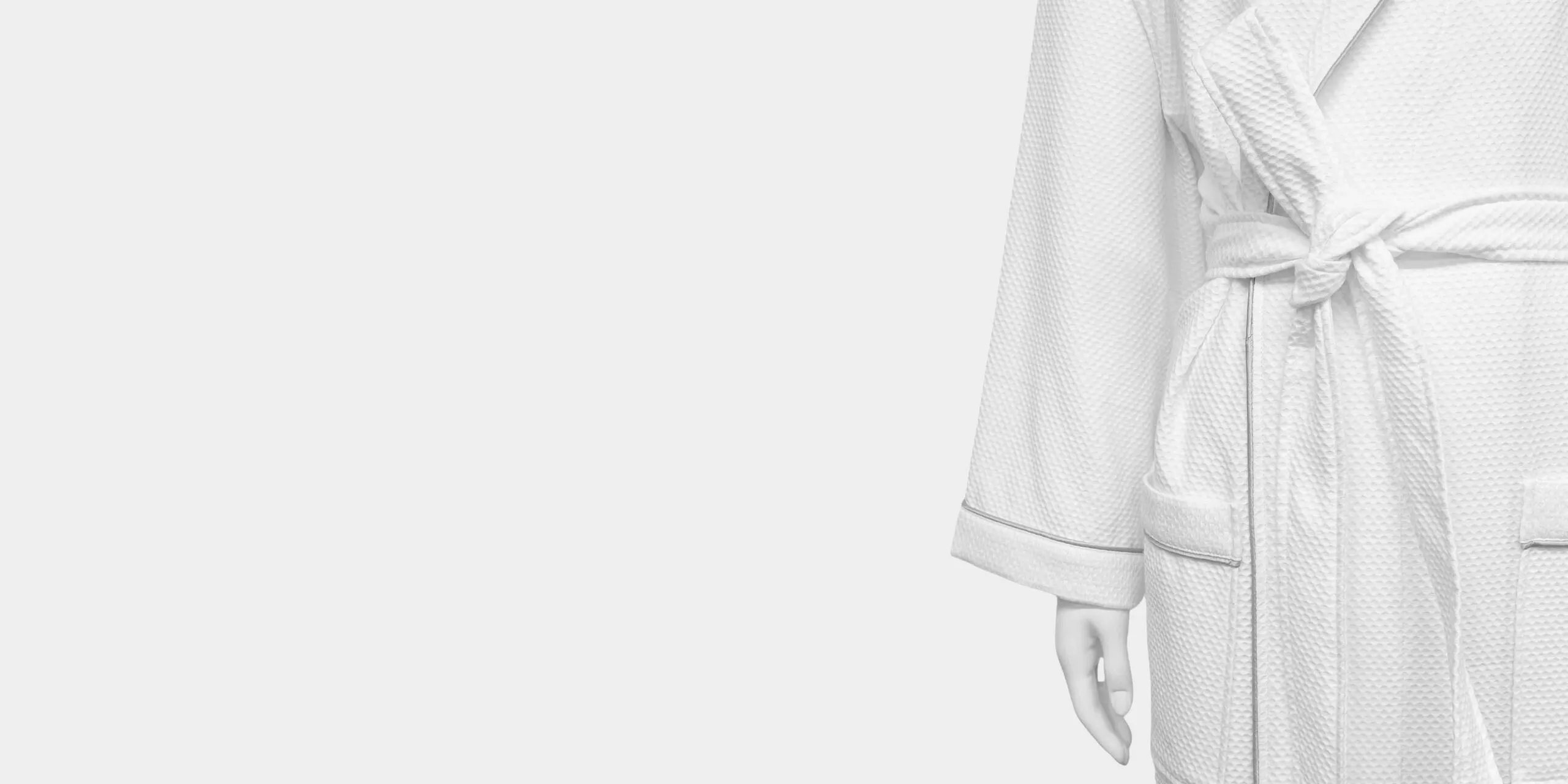 White waffle bathrobe with silver shoulder embroidery for hotel and spa programs.